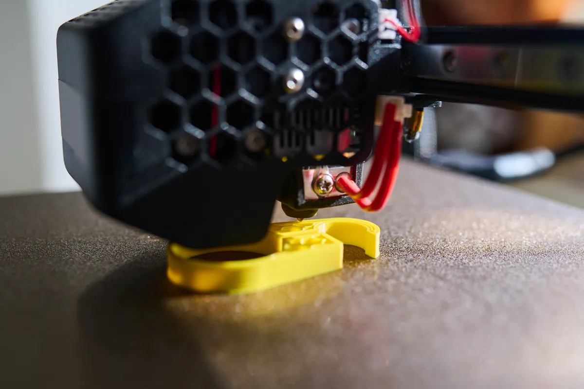 A 3D printer printing the first layers of a part