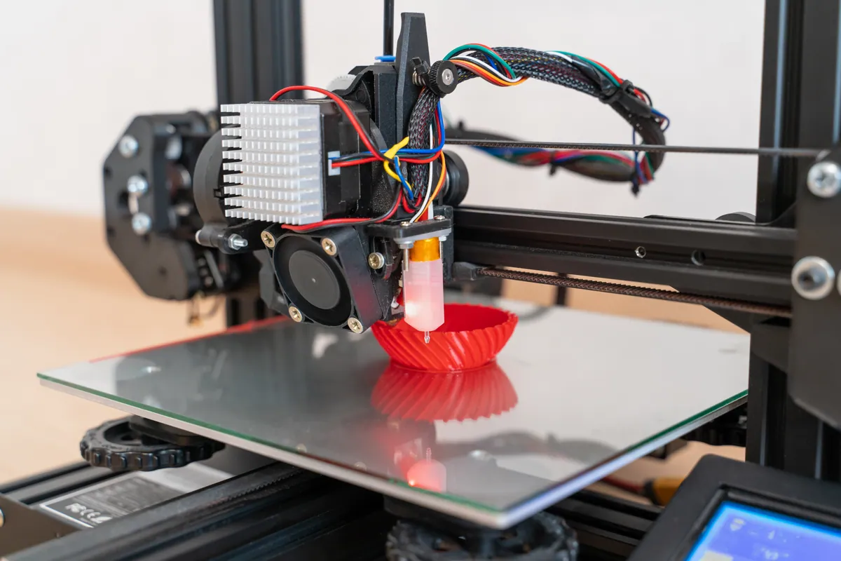 A modern 3D printer with filament spools