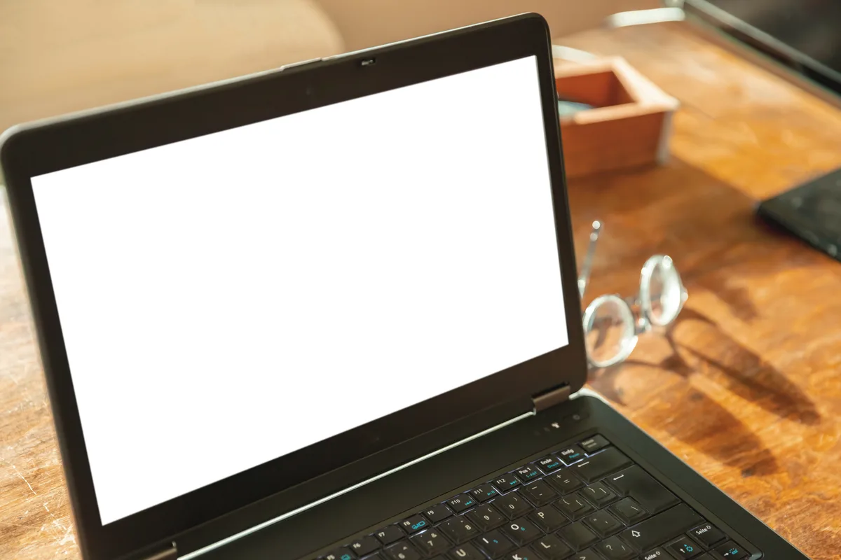 Technician providing remote IT support via secure screen sharing on a laptop