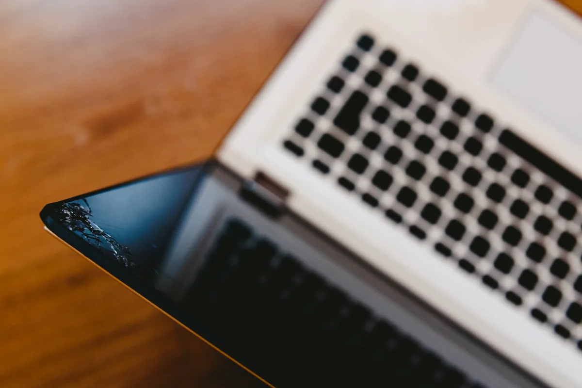 Laptop screen replacement in progress at a repair workshop