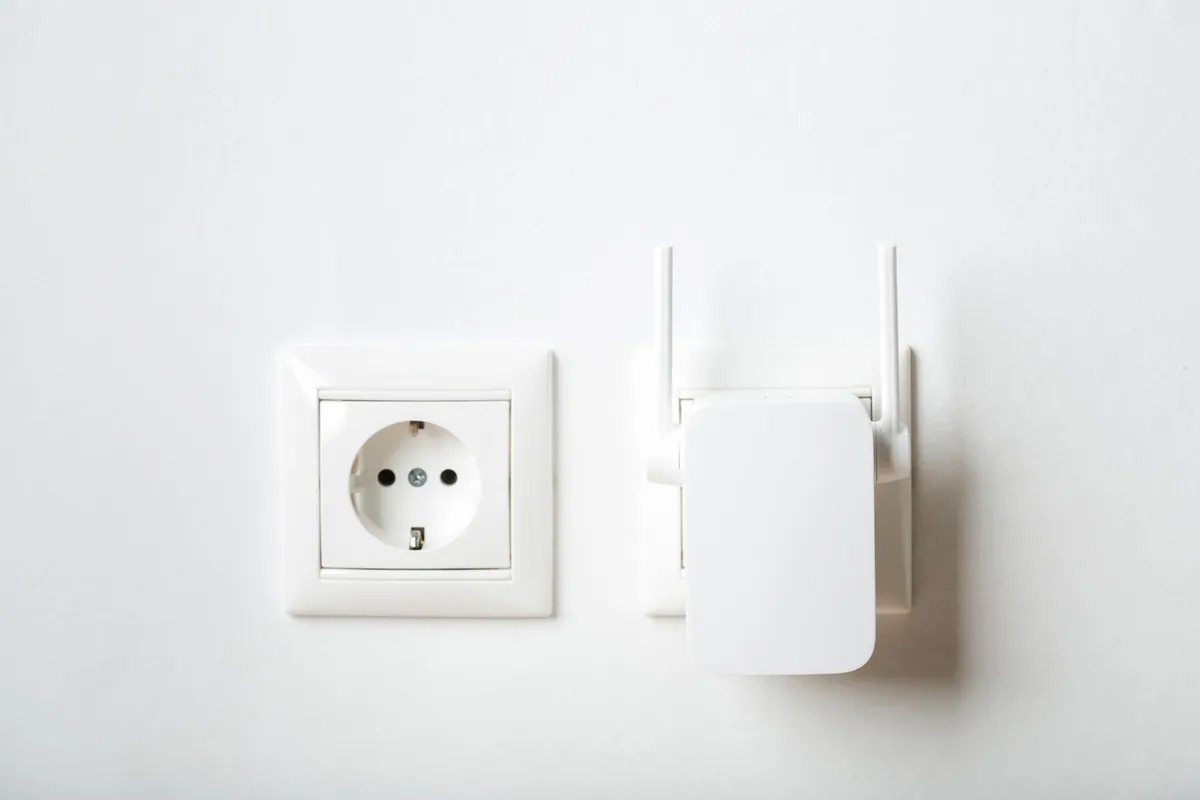 A Wi-Fi repeater plugged into a wall outlet