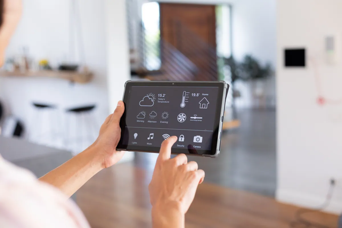 Controlling smart home lighting from a tablet app in a modern living room