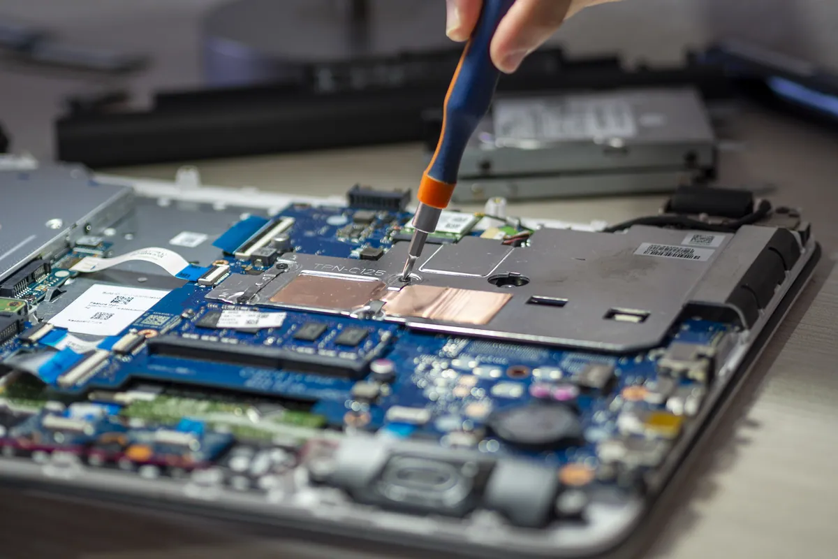 Close-up of a tablet being serviced on a workbench