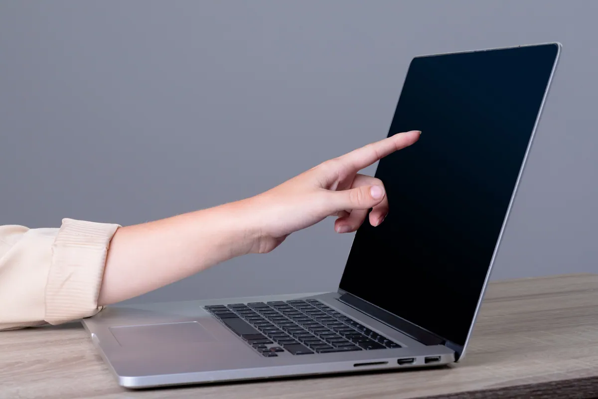 A businesswoman working on a laptop, representing professional domain email setup