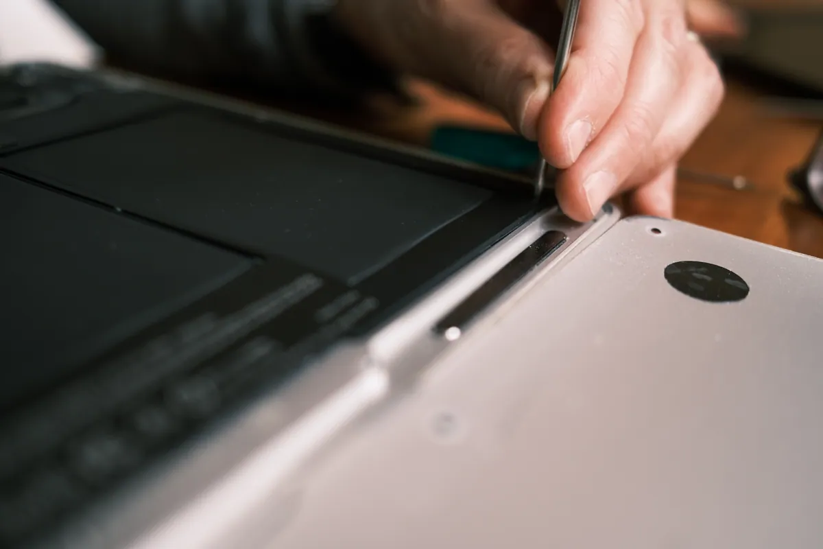 Technician using a screwdriver to repair a desktop PC with a boot fault