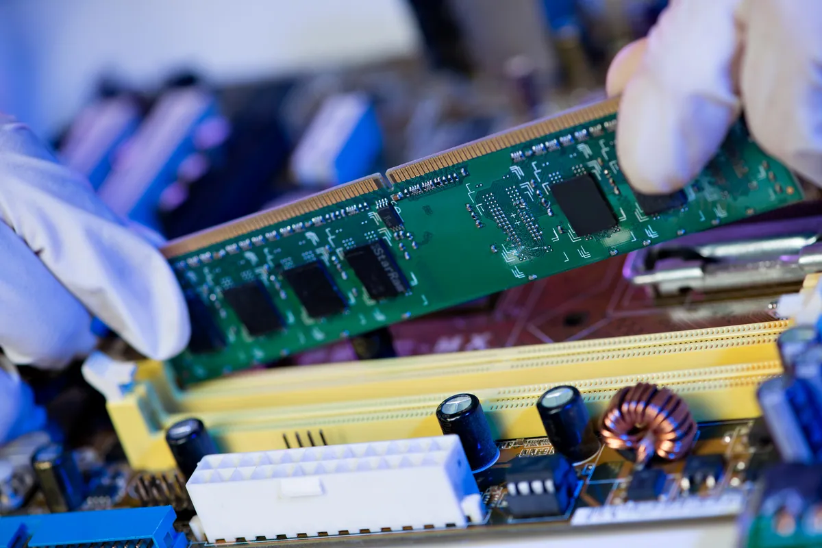 A RAM memory module being installed on a computer board