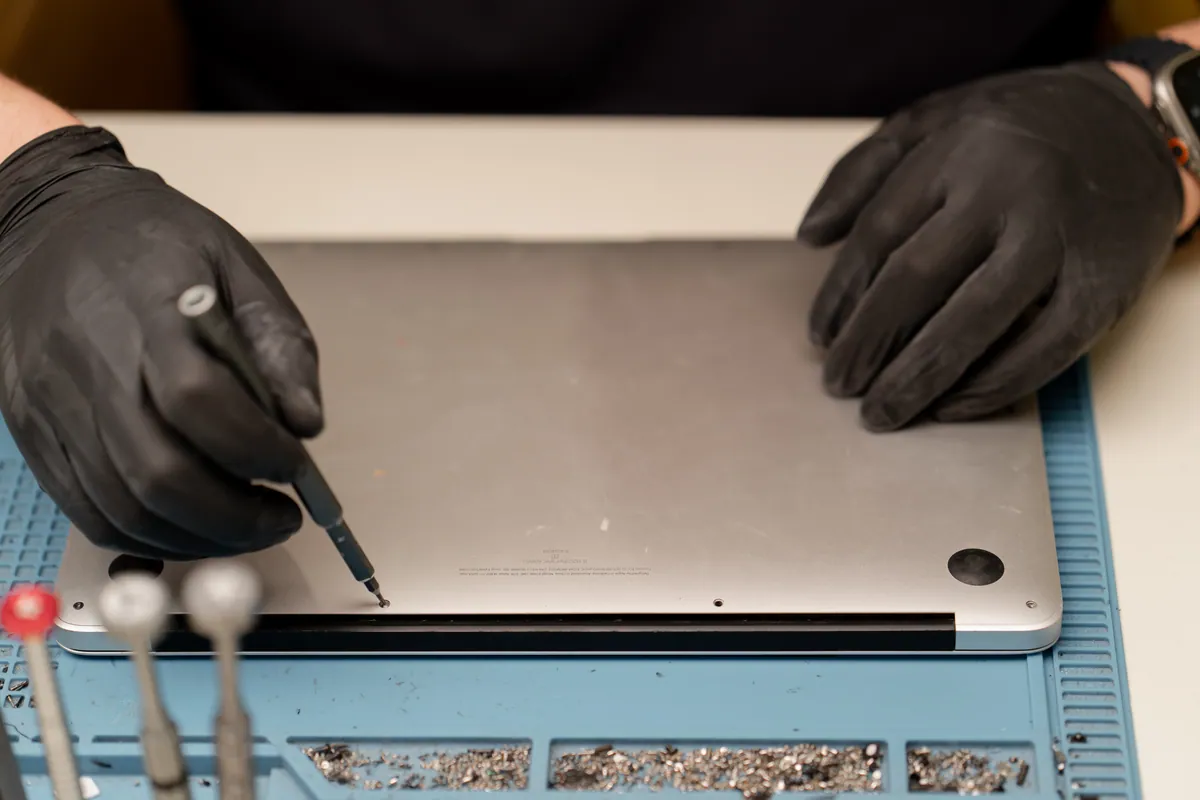 A technician replacing an internal component during a repair