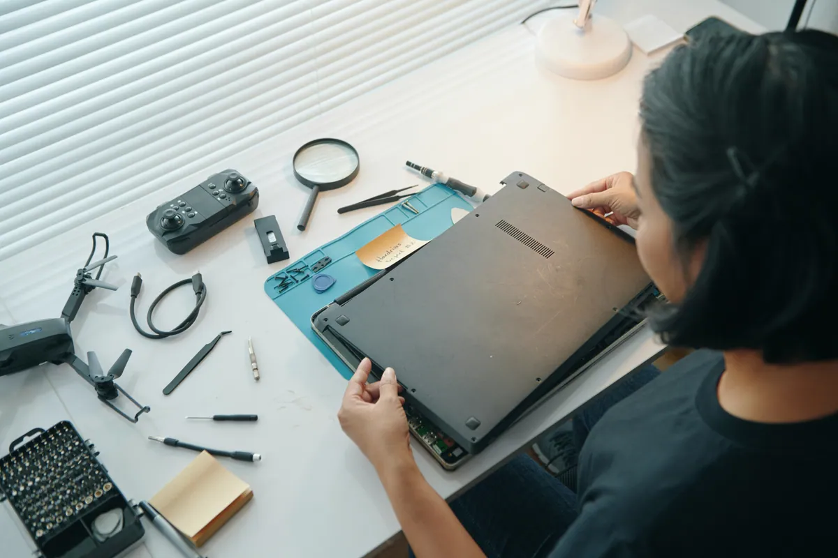 A computer being repaired and serviced at a workbench