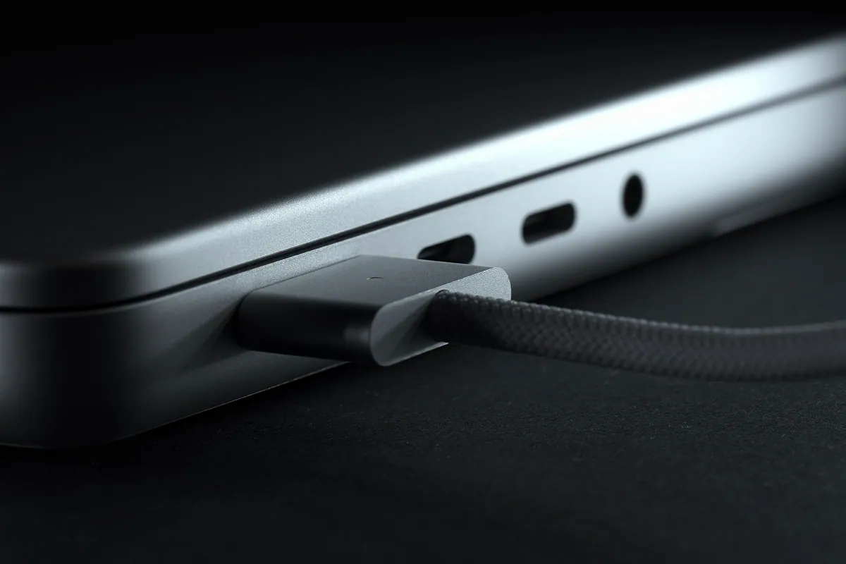 A MagSafe power adapter connecting to a MacBook