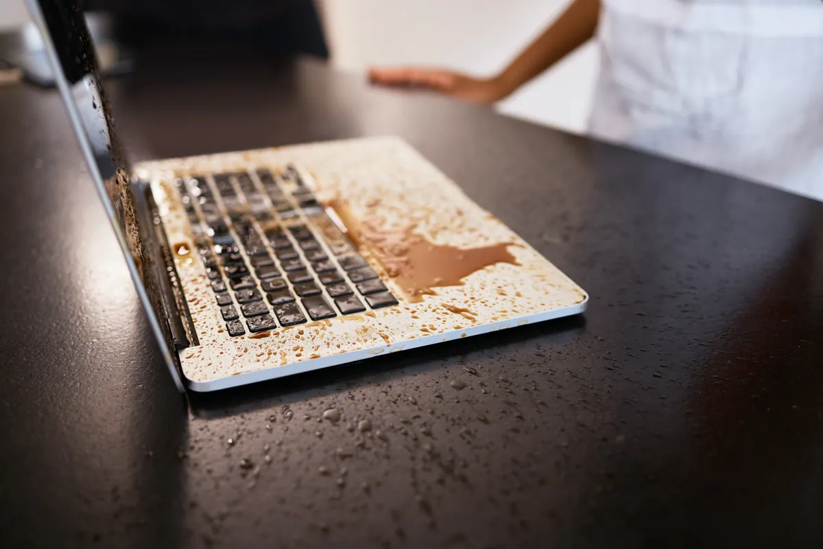 Coffee spilt over a laptop, causing liquid damage