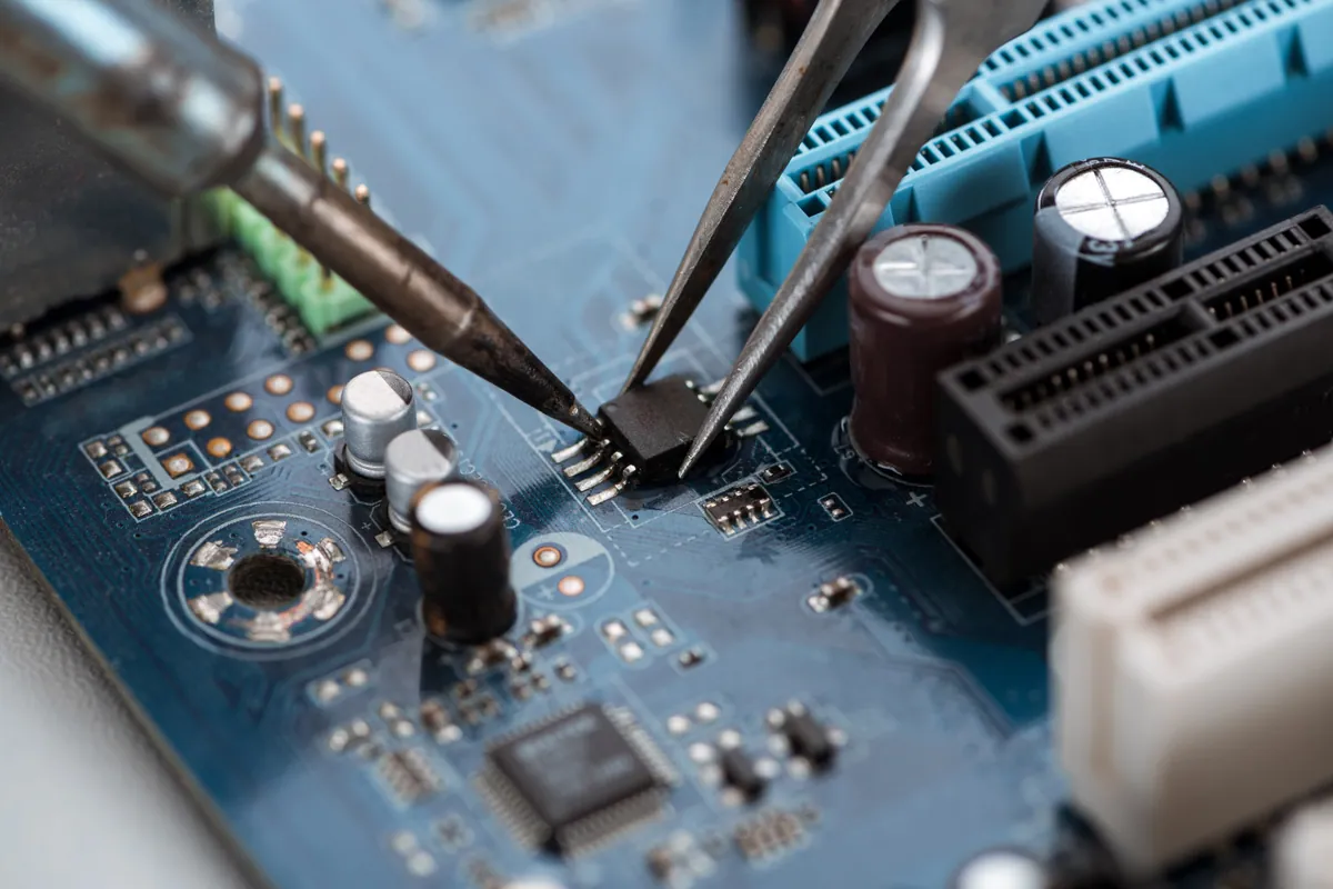 Soldering a component on a computer board during logic-board repair
