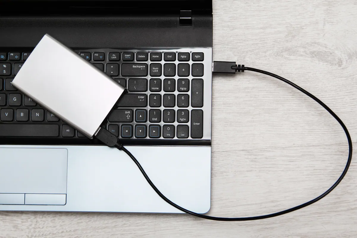 An external hard drive connected to a laptop for data recovery