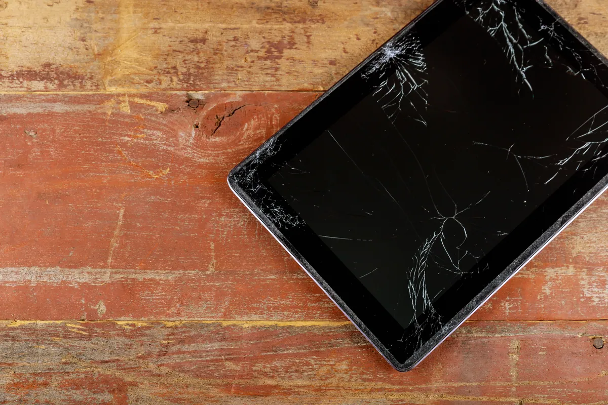 A Microsoft Surface tablet-style device with a damaged glass screen